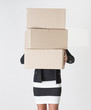 Woman carrying carboard boxes