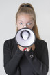 Young adult female holding a bullhorn
