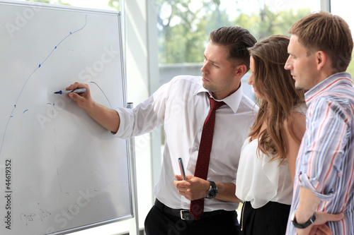 Photo: Business people looking at their leader while he explaining Business people looking at their leader while he explaining