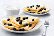 French crepes with blueberries and cream