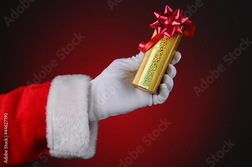 Photo: Santa Claus Hand Holding Present Santa Claus Hand Holding Present