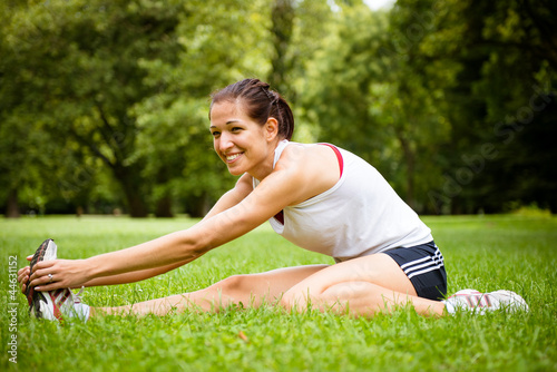 Photo: Stretching exercise - sport woman outdoor Stretching exercise - sport woman outdoor