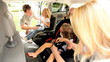 Parents Putting Children Family Car Seats