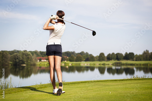 Photo: Golf player teeing off Golf player teeing off