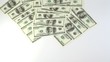 Hundred dollar banknotes appear and disappear from screen