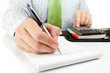 Businessman counting on calculator.
