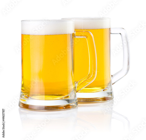 Photo: Two glasses of fresh beer with foam isolated on white background Two glasses of fresh beer with foam isolated on white background