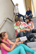 Students talking relaxing on school steps teens