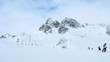 Many skiers go down to mountain bottom