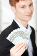 Photo: Young handsome businessman holding euros Young handsome businessman holding euros