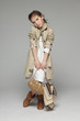 Little girl wearing trench coat holding handbag