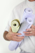 Man holding rolls of wallpaper