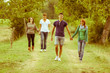 Group of Teenagers Walking Holding Hands