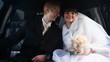 Newly-married couple sits in car together