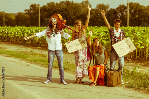 Photo: Hippie Group Hitchhiking on a Countryside Road Hippie Group Hitchhiking on a Countryside Road