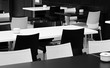 Street small cafe with bw tables and chairs.