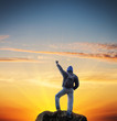 Man on peak of mountain.