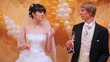 Newly-married couple dances holding in hands glasses