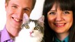 Young couple and cat look isolated
