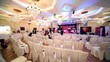 Several people sit in conference hall