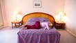 Young woman runs and jumps on bed then lies on it