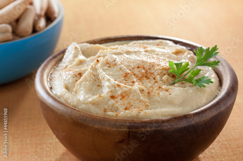 Photo: bowl of homemade hummus with breadsticks bowl of homemade hummus with breadsticks