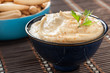 bowl of homemade hummus with breadsticks