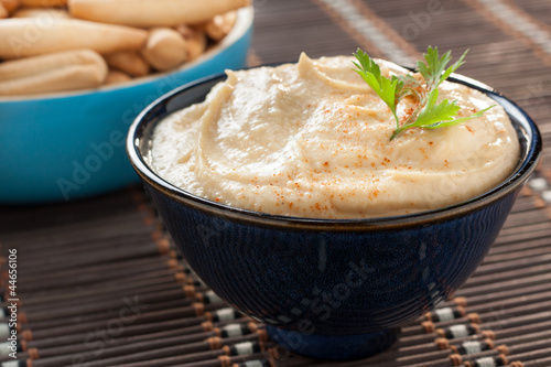 Photo: bowl of homemade hummus with breadsticks bowl of homemade hummus with breadsticks