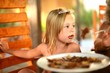 Happy girl eating a pancake
