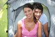 Couple sat by entrance to tent