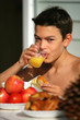 Young boy drinking orange juice in the garden