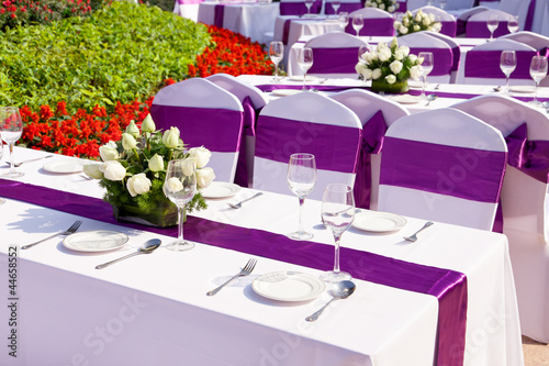 Photo: outdoor tables with served plate and wine glasses outdoor tables with served plate and wine glasses