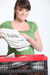 Woman recycling newspaper