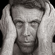 Gritty Closeup Portrait of a Man Clutching his Head