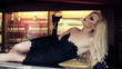 Gorgeous blonde woman lying on bar counter with wine