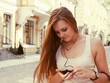 Young Woman Listening to Music Outdoors