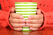 hands holding mug of hot drink close-up