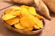 Photo: Crispy Peruvian sweet potato chips on wooden plate Crispy Peruvian sweet potato chips on wooden plate