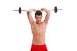 young shirtless man lifting a barbell above head