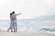 Photo: Picture of romantic young couple on the sea shore Picture of romantic young couple on the sea shore