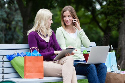 Photo: Shopping Women Using Digital Tablet and Cellphone Shopping Women Using Digital Tablet and Cellphone