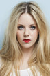 Close-up portrait of beautiful young woman with blond hair and red lips