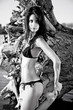 Beautiful brunette posing  on river bank.