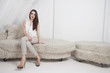 Portrait of beautiful young woman sitting on sofa