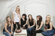 Female friends celebrating young woman's birthday