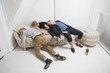 Drunk male friends sleeping on fur sofa after party