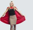 Portrait of beautiful woman in superhero costume over light blue background