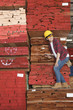 Photo: Asian female industrial worker standing on stacked wooden planks holding tablet PC Asian female industrial worker standing on stacked wooden planks holding tablet PC