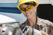 Photo: Mid adult female industrial worker buffing a truck engine cylinder Mid adult female industrial worker buffing a truck engine cylinder