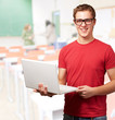 Portrait Of A Young Man Holding A Laptop